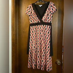 Brown and orange cat-eye fabric dress with tie at waist.